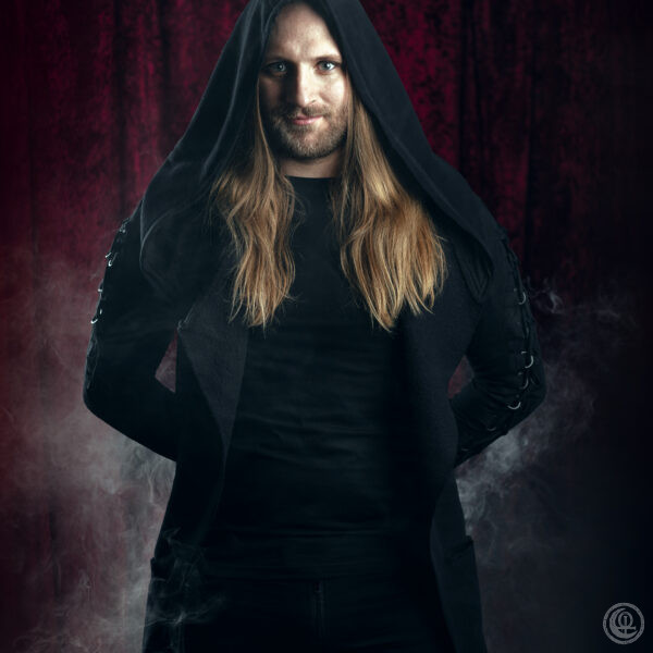 Rigo Ryll

I’m Rigo, Coven Call’s new guitarist. The band enchanted me with their versatile compositions
and
their original blend of symphonic and death metal.
I have two very talented sisters who already introduced me to music in my early childhood.
I picked up playing guitar when I was with the scouts, until I eventually formed my first metal
band.
My goal is to add even more complexity to Coven Call’s music and to stir the audience during live
performances.
In my playing I pull a lot of inspiration from my favorite bands. I aim to be succinct like Led
Zeppelin, singable like Muse, powerful like Blind Guarding, progressive like Tyr and playful like
Ӕther Realm.
Outside of music, I burn for trading card games. I’m especially captivated by the hand-drawn dark
fantasy style of Sorcery: Contested Realms.